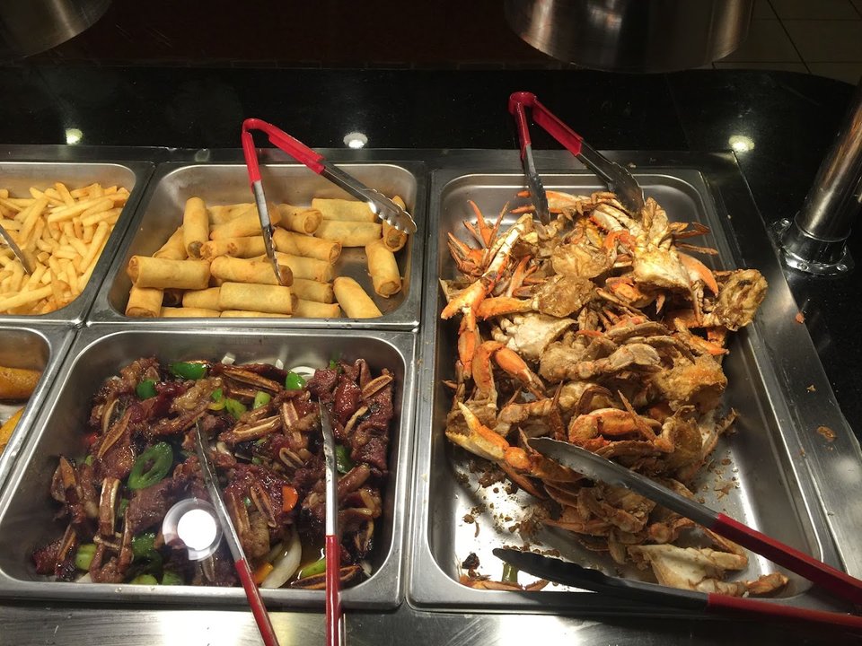 Rows of hot dishes behind glass